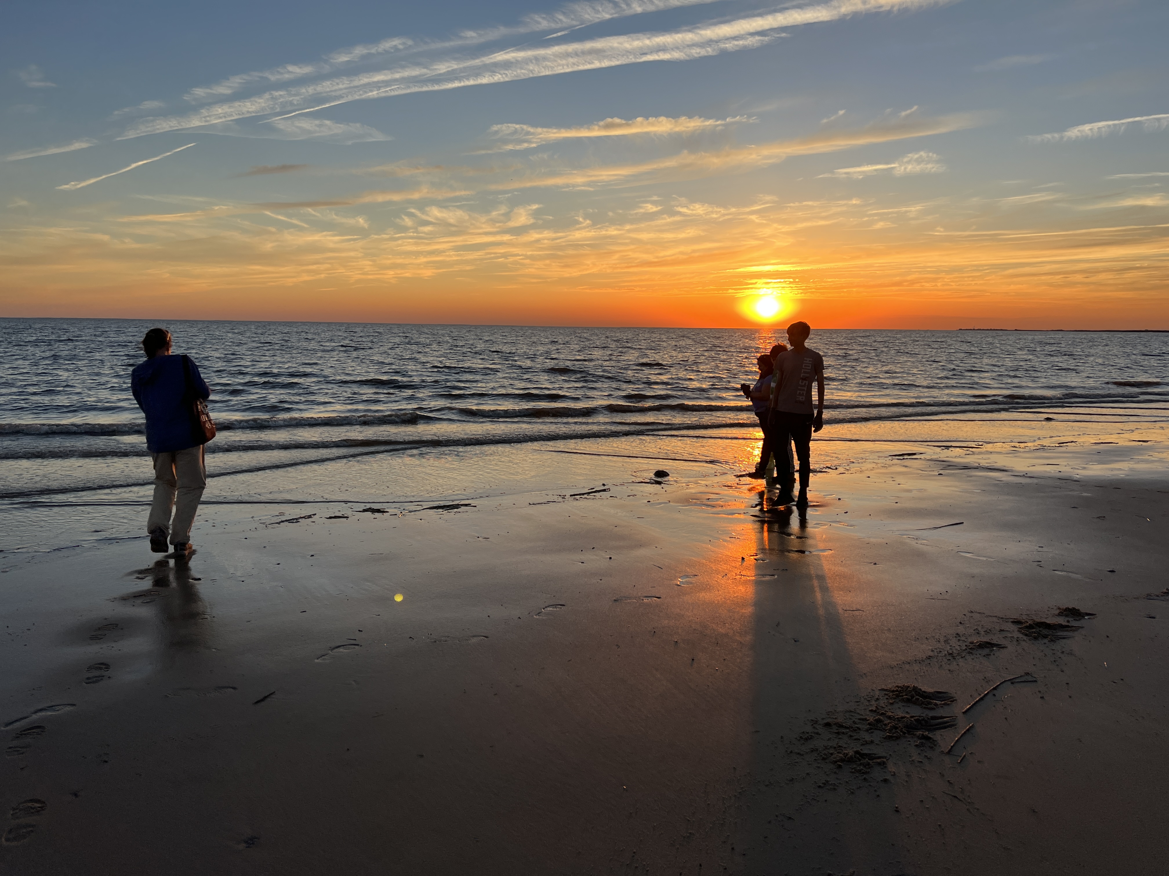 People on beach at dusk.